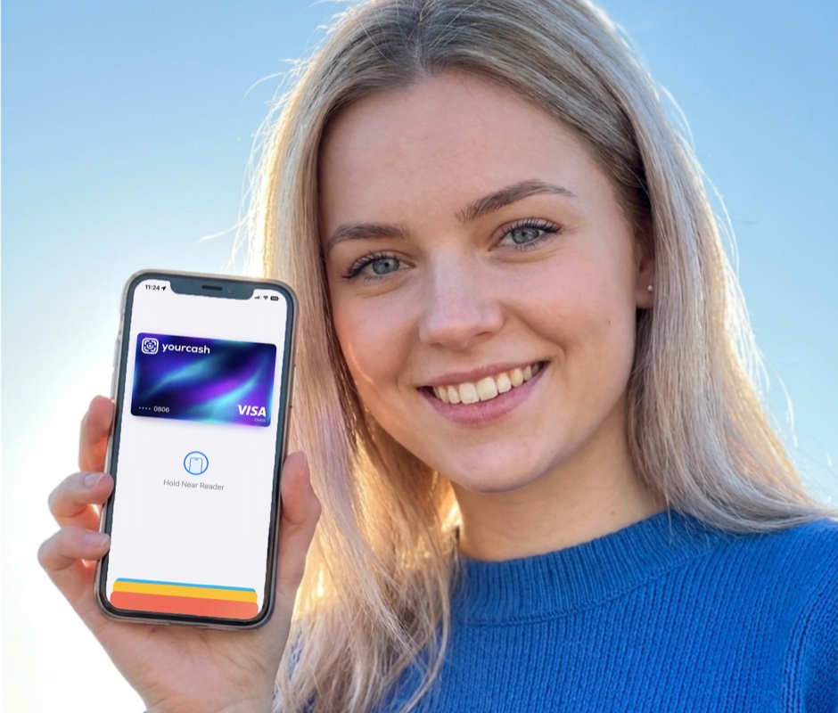 Žena drží telefón s kartou Yourcash Visa pripravenou na platbu